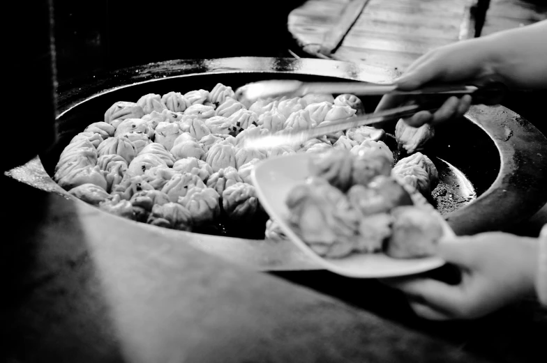 black and white po of a woman cooking food