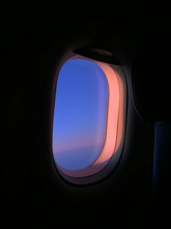 an airplane's window during flight time is pictured