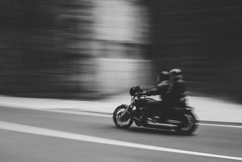 a blurry po of someone riding a motorcycle down the street