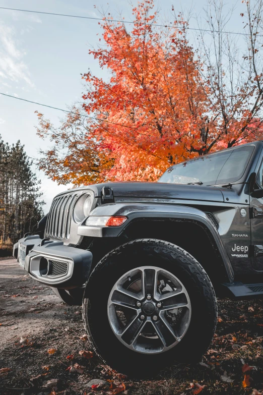 a black jeep is parked on some dirt