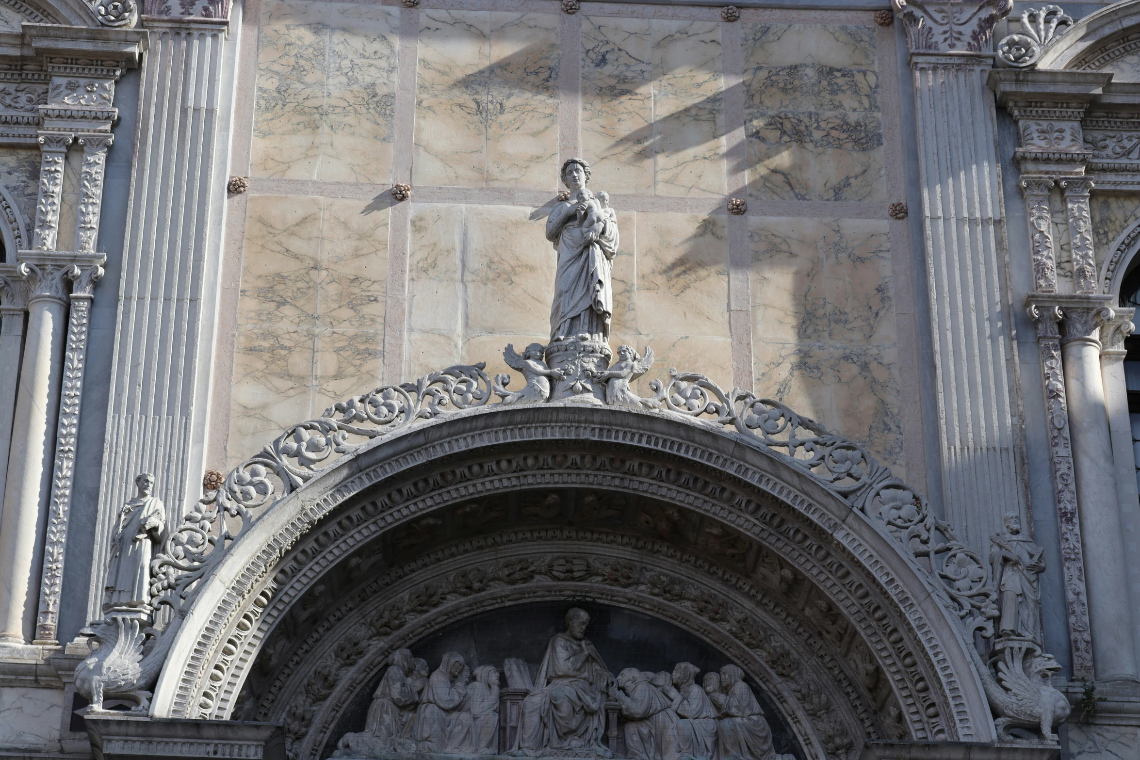 the stone facade of the building is decorated with statues