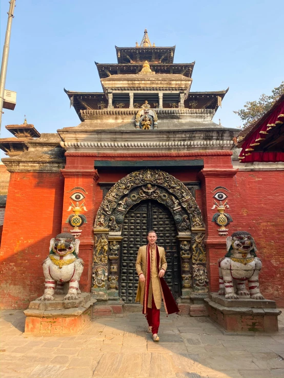 a woman stands in front of the entrance of a palace