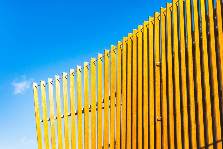 a large yellow wall next to a tall brick building