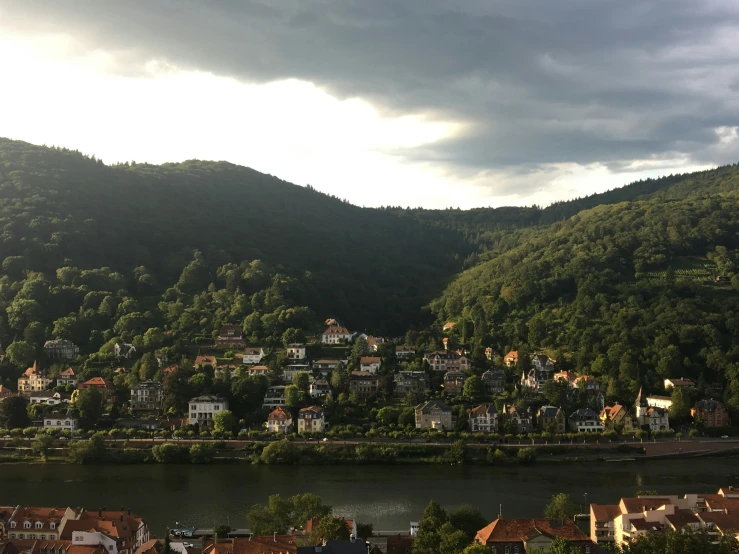 a city next to a body of water surrounded by mountains