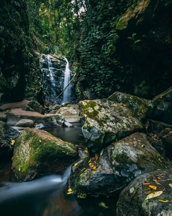 a small waterfall in the middle of an outdoor area