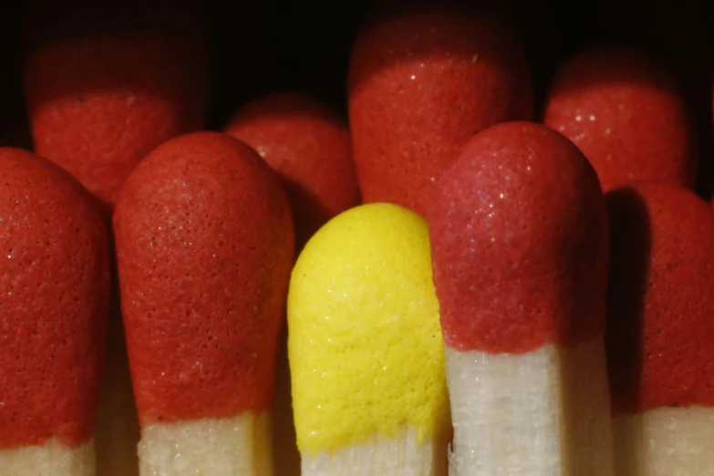 red and white matchesticks with yellow matchsticks in front