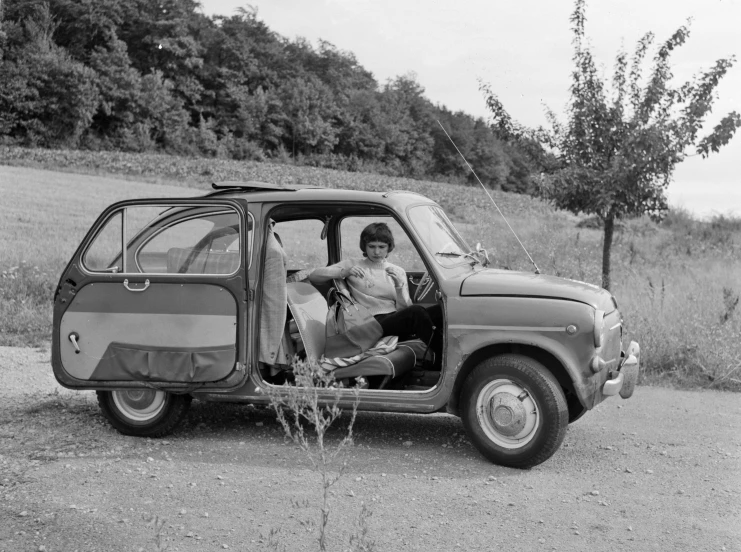 a young person sitting in the passenger seat of a small truck