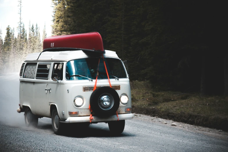 a vw bus is driving down the road