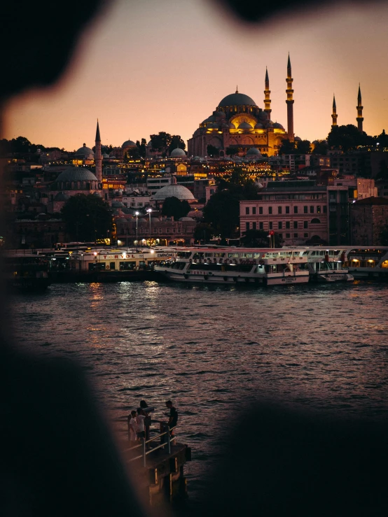 a boat on a body of water with buildings in the background