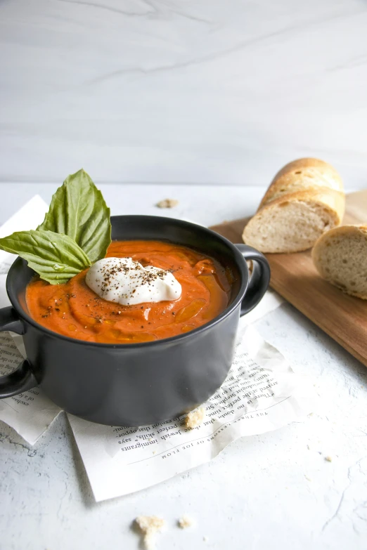 a pot full of soup on top of a  board