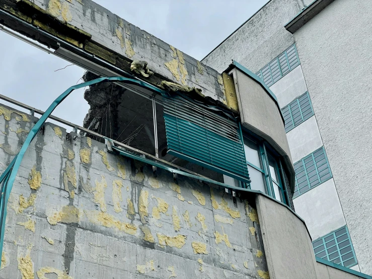 a broken down building that has an air duct vent attached to it