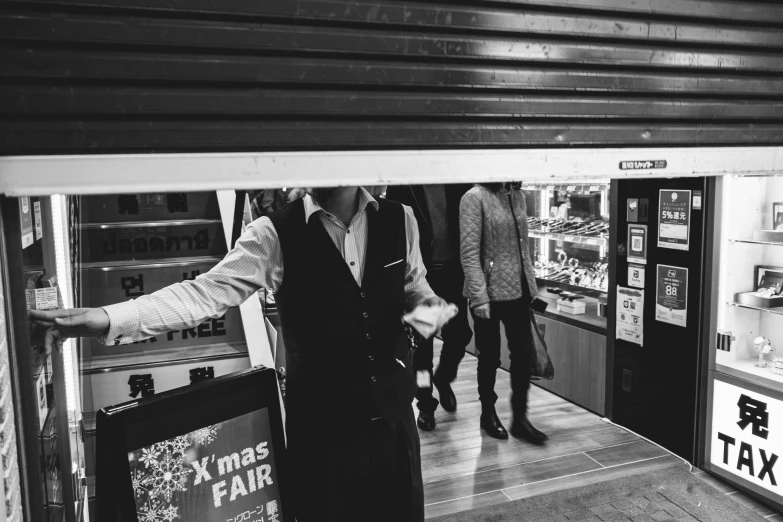 a couple of men are looking inside of the store