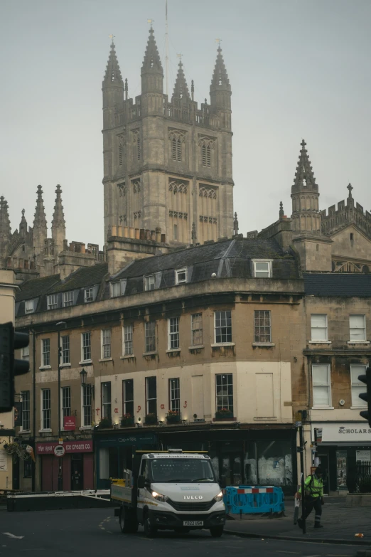 some buildings and a man in a blue vest