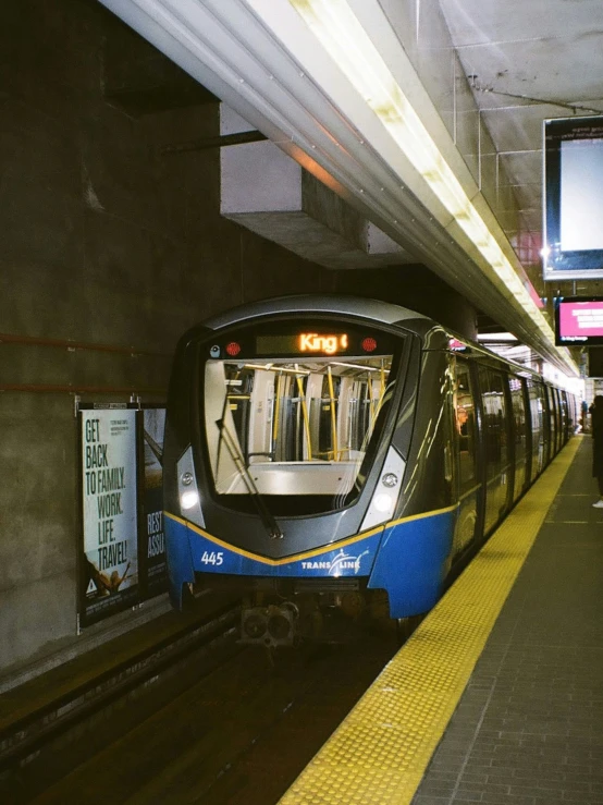 a subway train is at the station by its stop