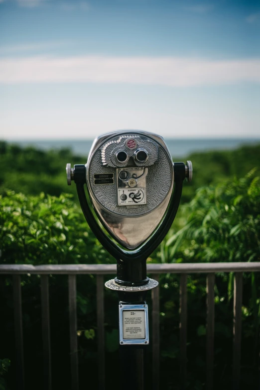 a coin operated parking meter is sitting on a balcony