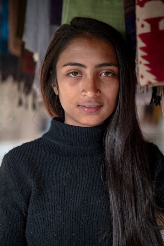 a woman standing with her hands on the shoulder of a brown long haired