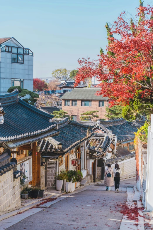 a man and woman are walking down a street