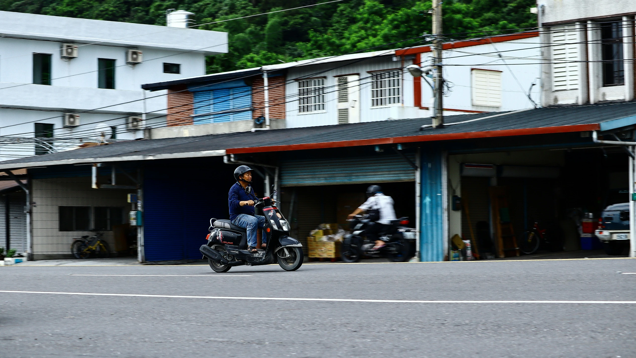 a group of motorcycles driving through a garage