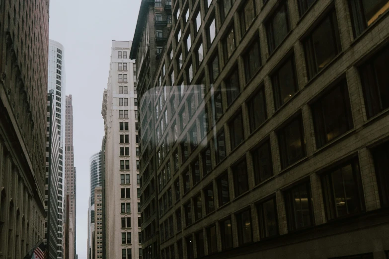 tall buildings on the street near a sidewalk in a city