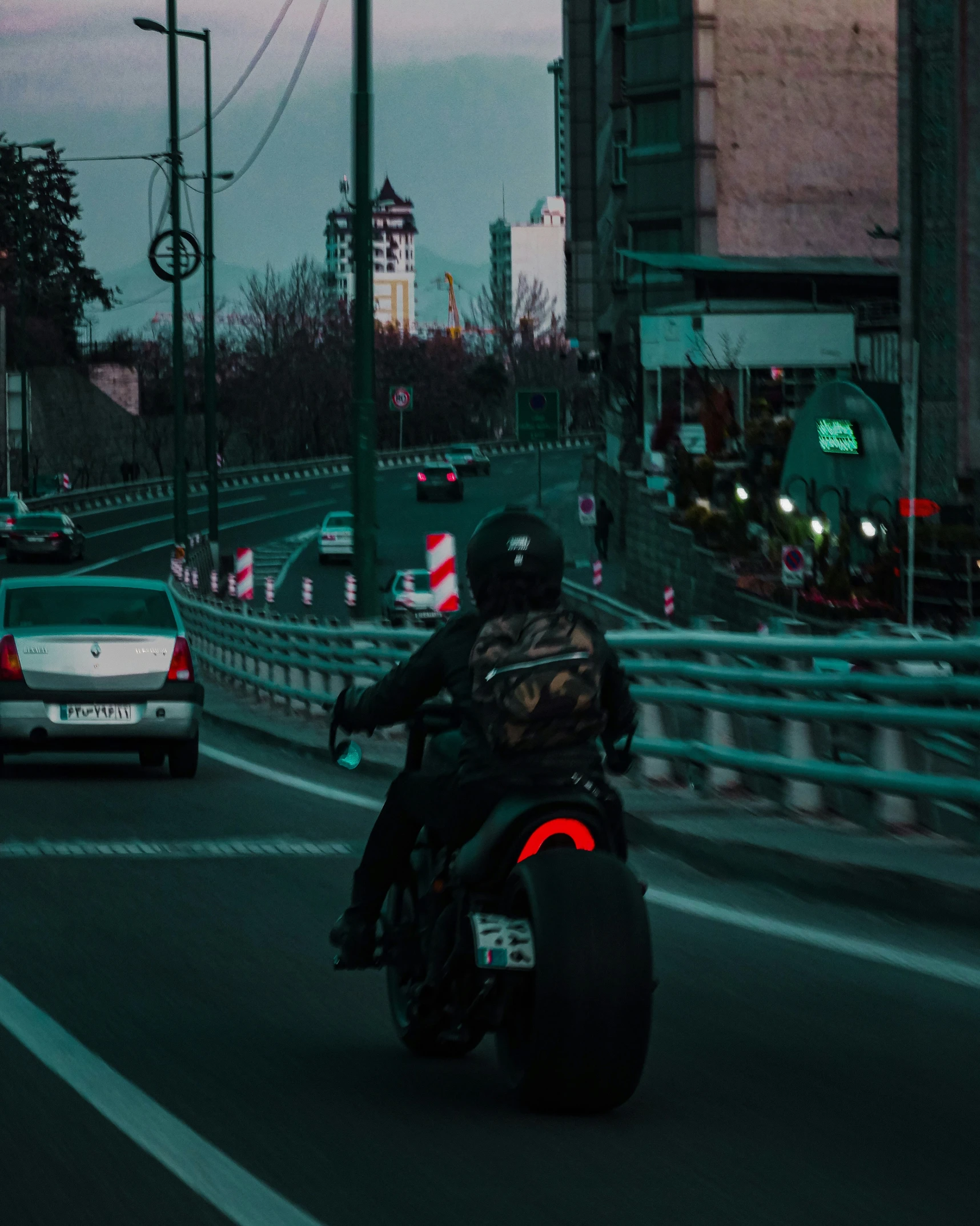 a person on a motorcycle rides through traffic