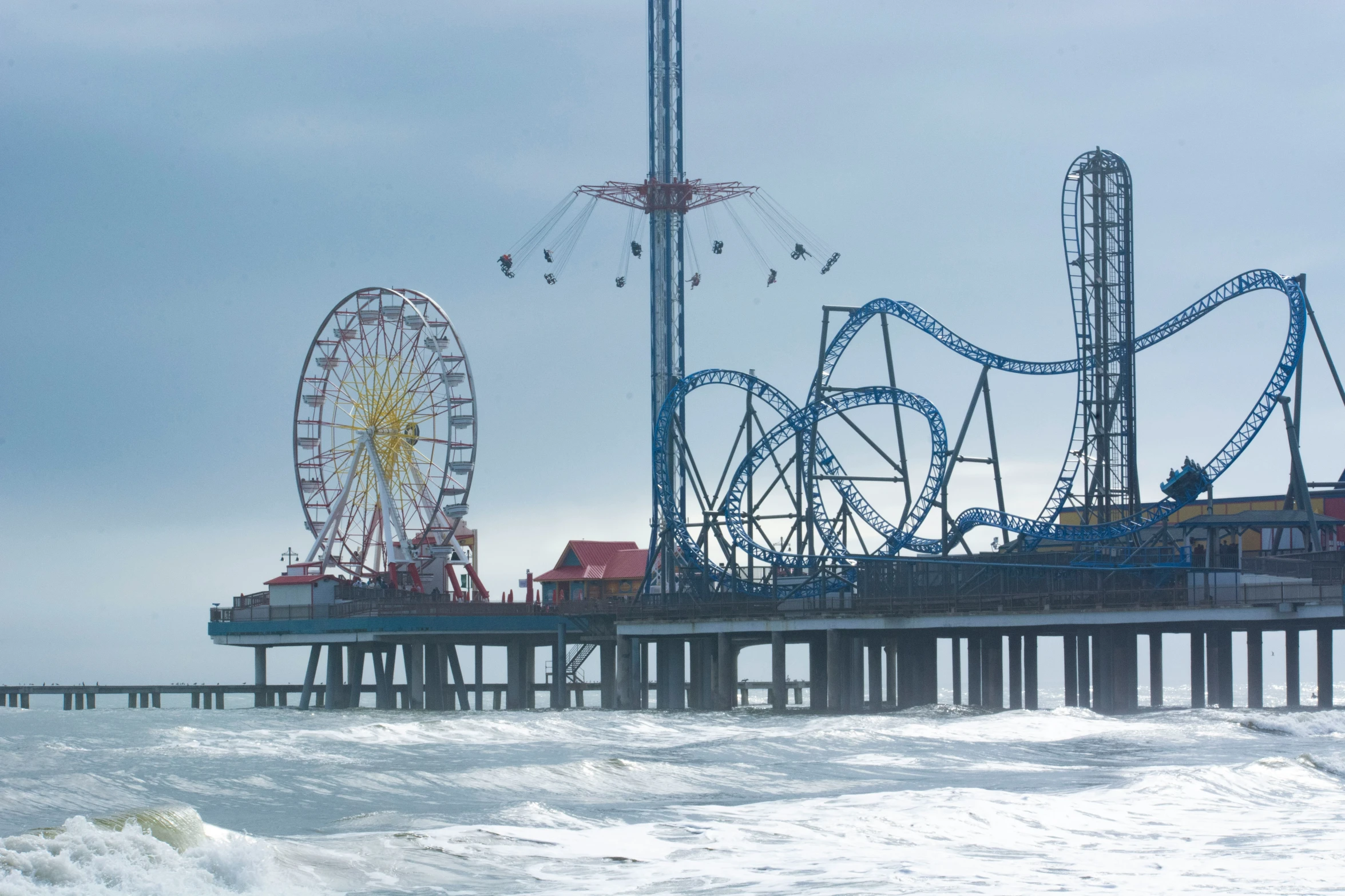 the boardwalk and rides are along the pier