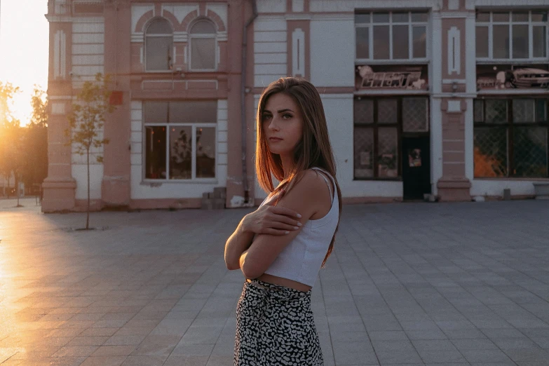 an attractive woman posing in front of an old building