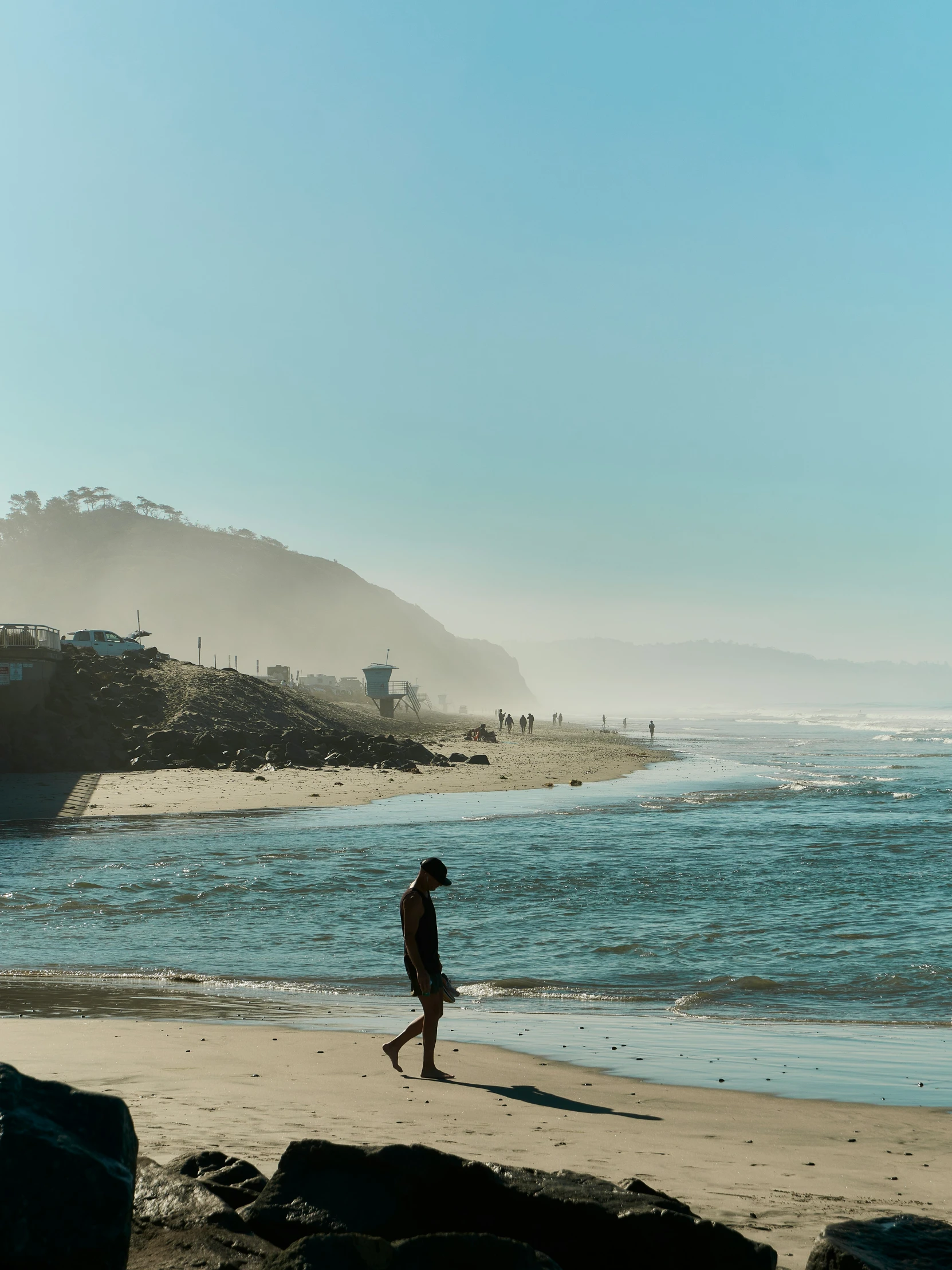 a person standing on a beach next to the ocean