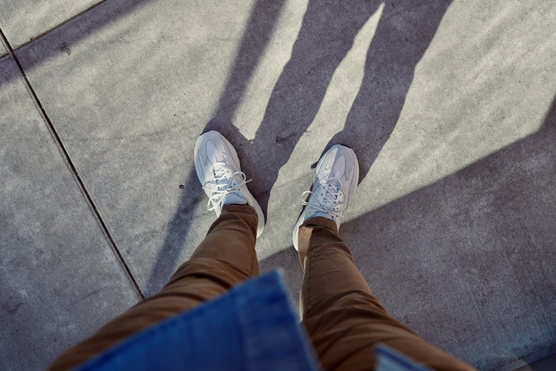 a person stands in shadow and has their legs stretched up