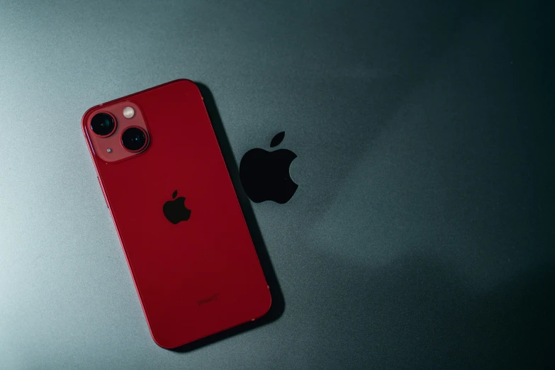 a red iphone 11 and an apple camera