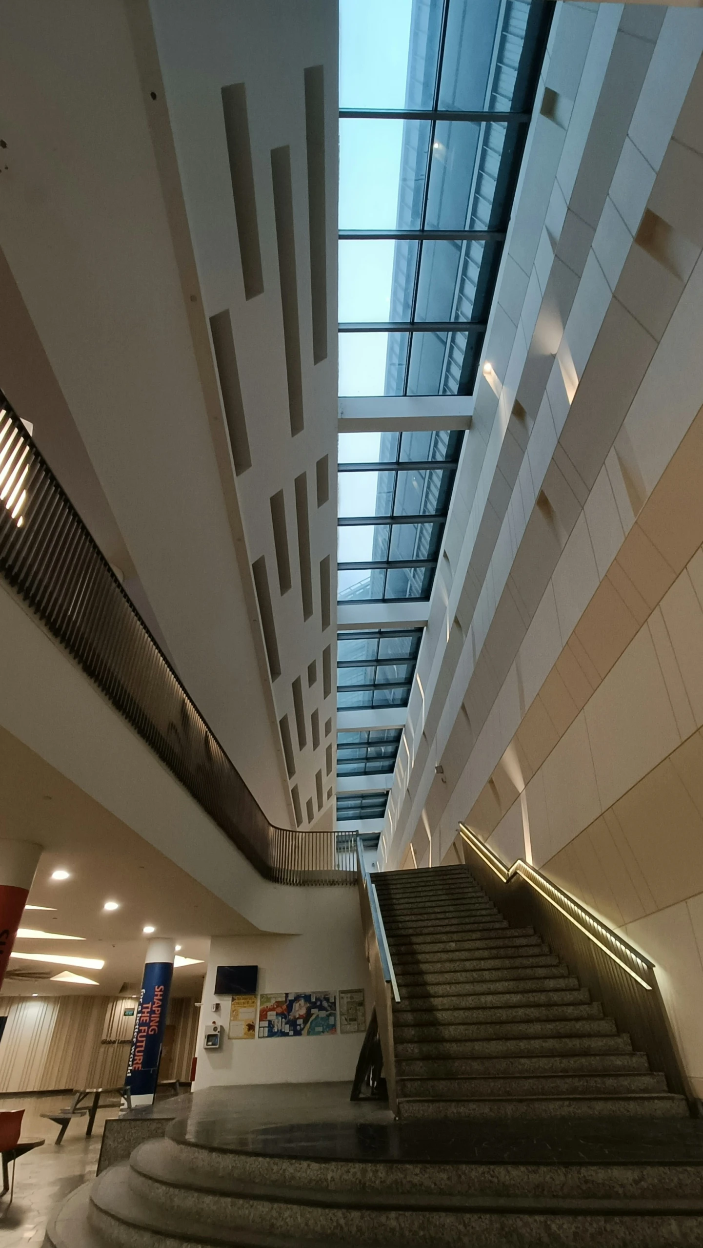 a hallway with steps and skylights going up