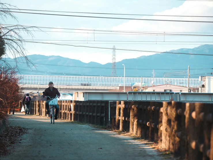 a person on a bicycle traveling on a path