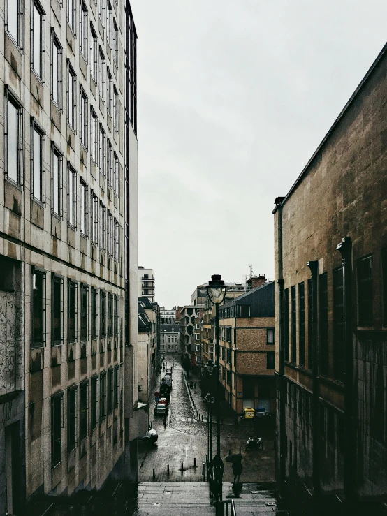 a narrow city street lined with tall buildings