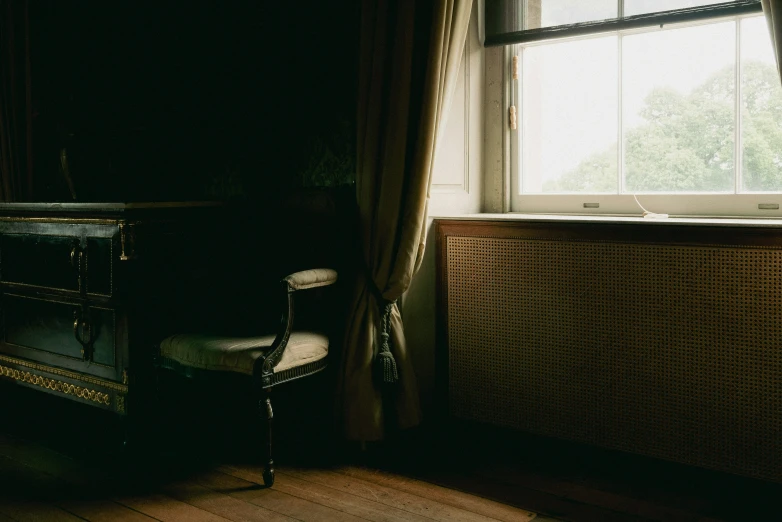 an empty chair sits in front of a window
