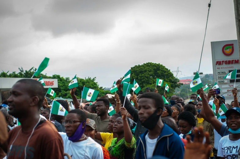 a large group of people holding up their hands