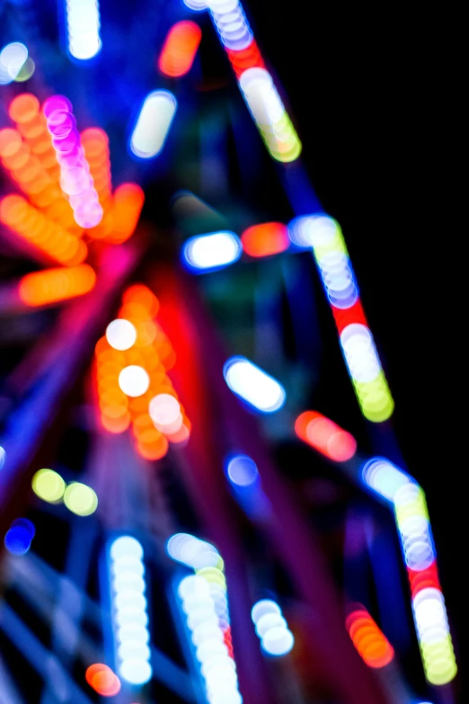 a fair ride with colored lights and a black background