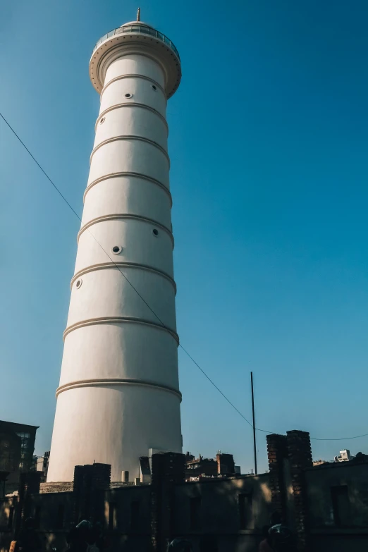 a white light house sitting on top of a building