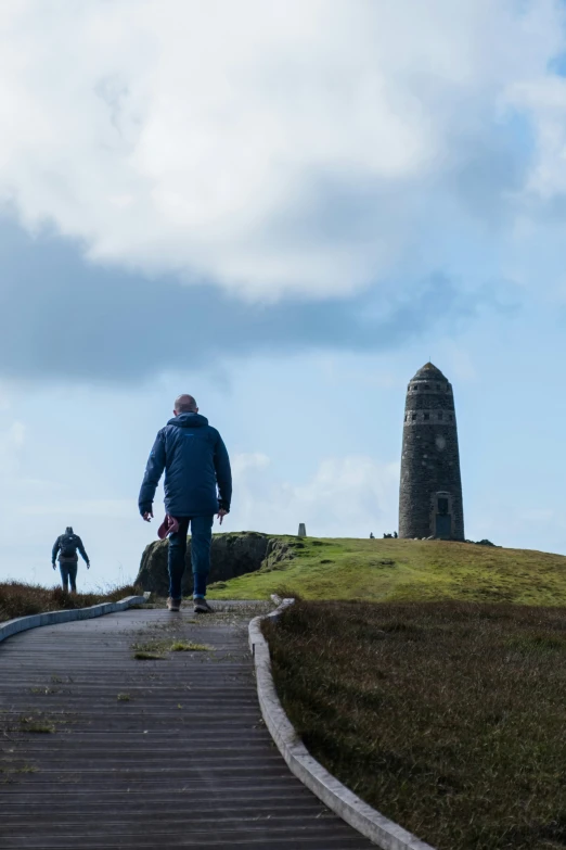 a couple of people standing on top of a hill