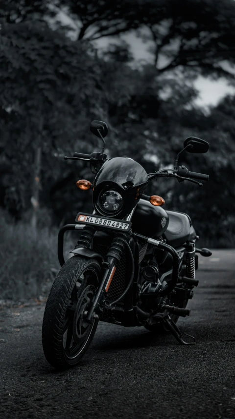 a black motorcycle parked on top of a parking lot