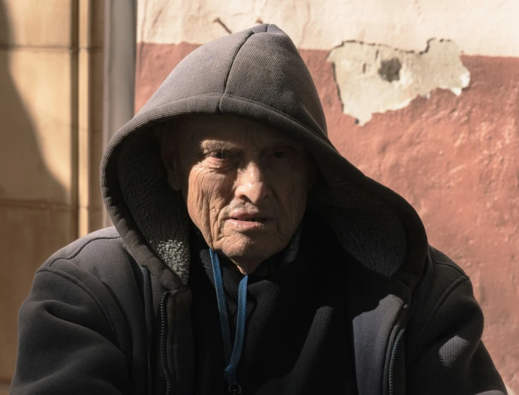 an elderly man is posing for a po