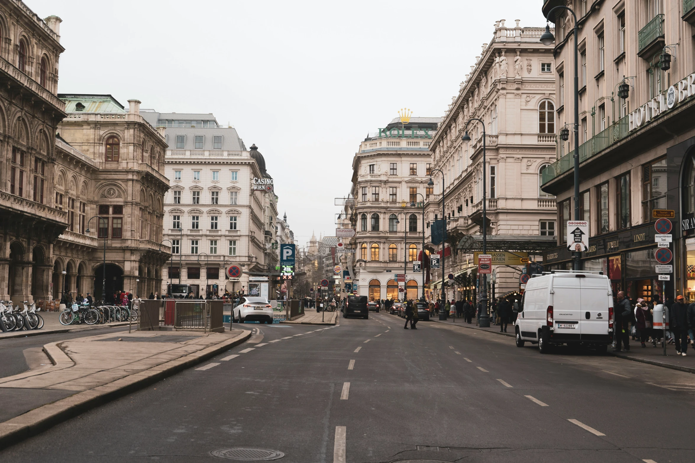 a narrow, empty city street with a traffic light in the middle