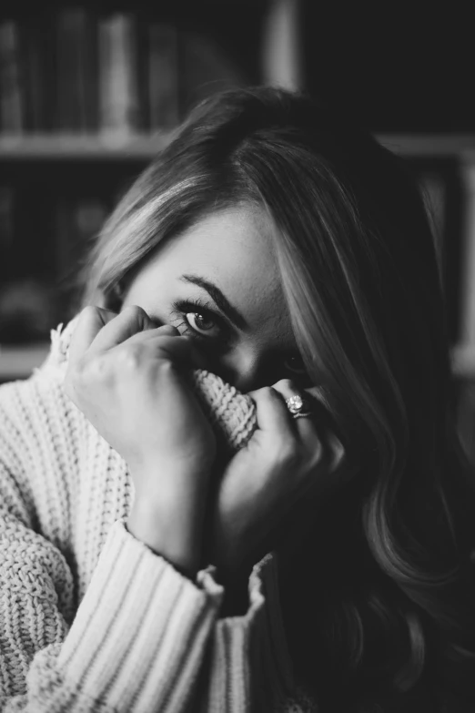 a woman covers her face with her hands