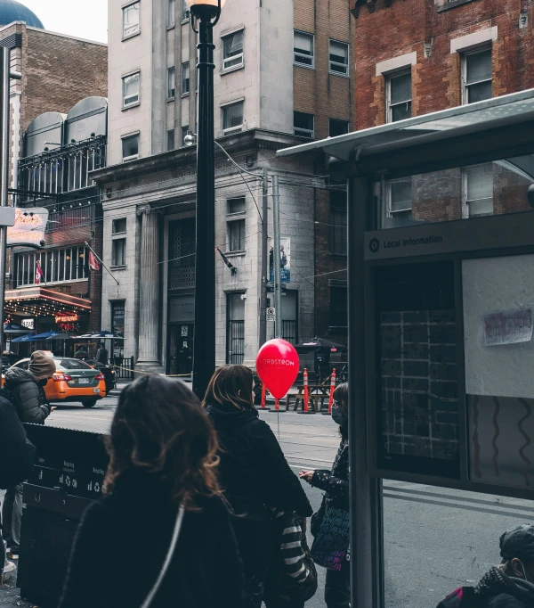 people walking around in the city on a cloudy day