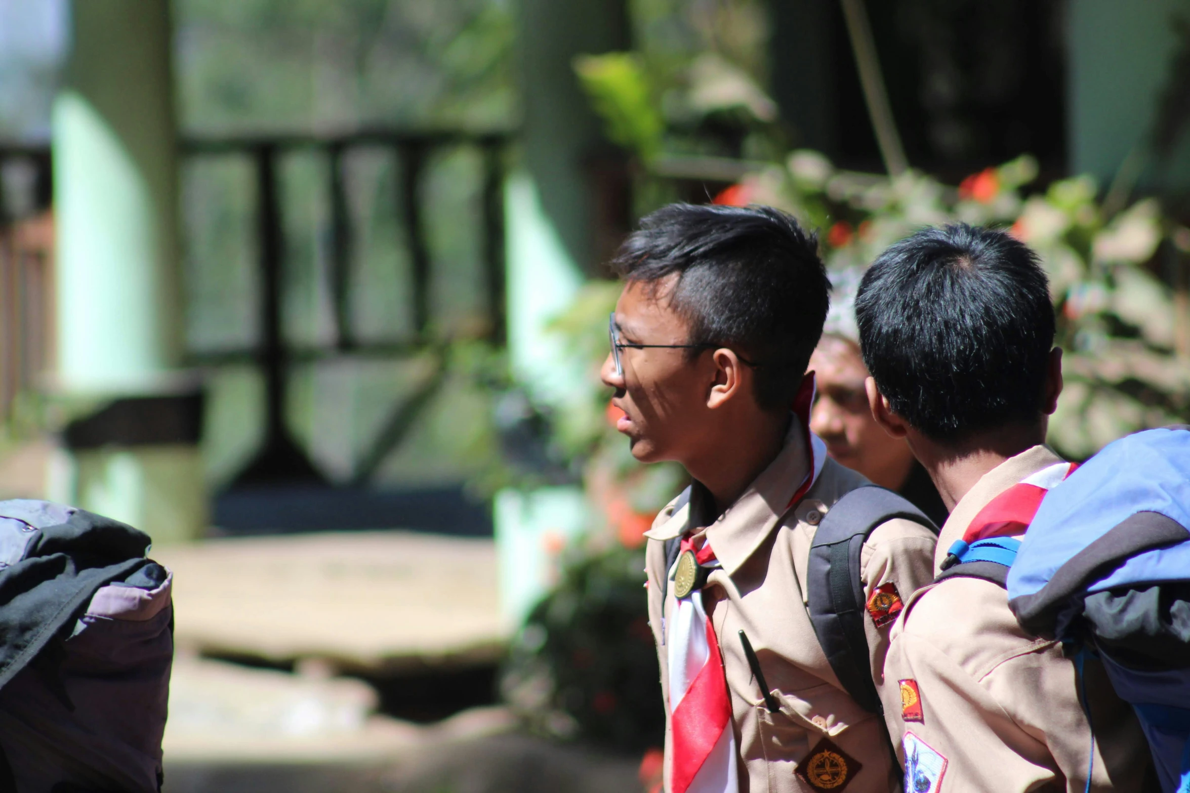 three people wearing jackets standing around