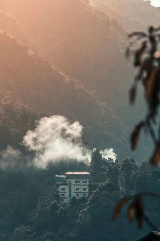 a building that has a roof is surrounded by trees