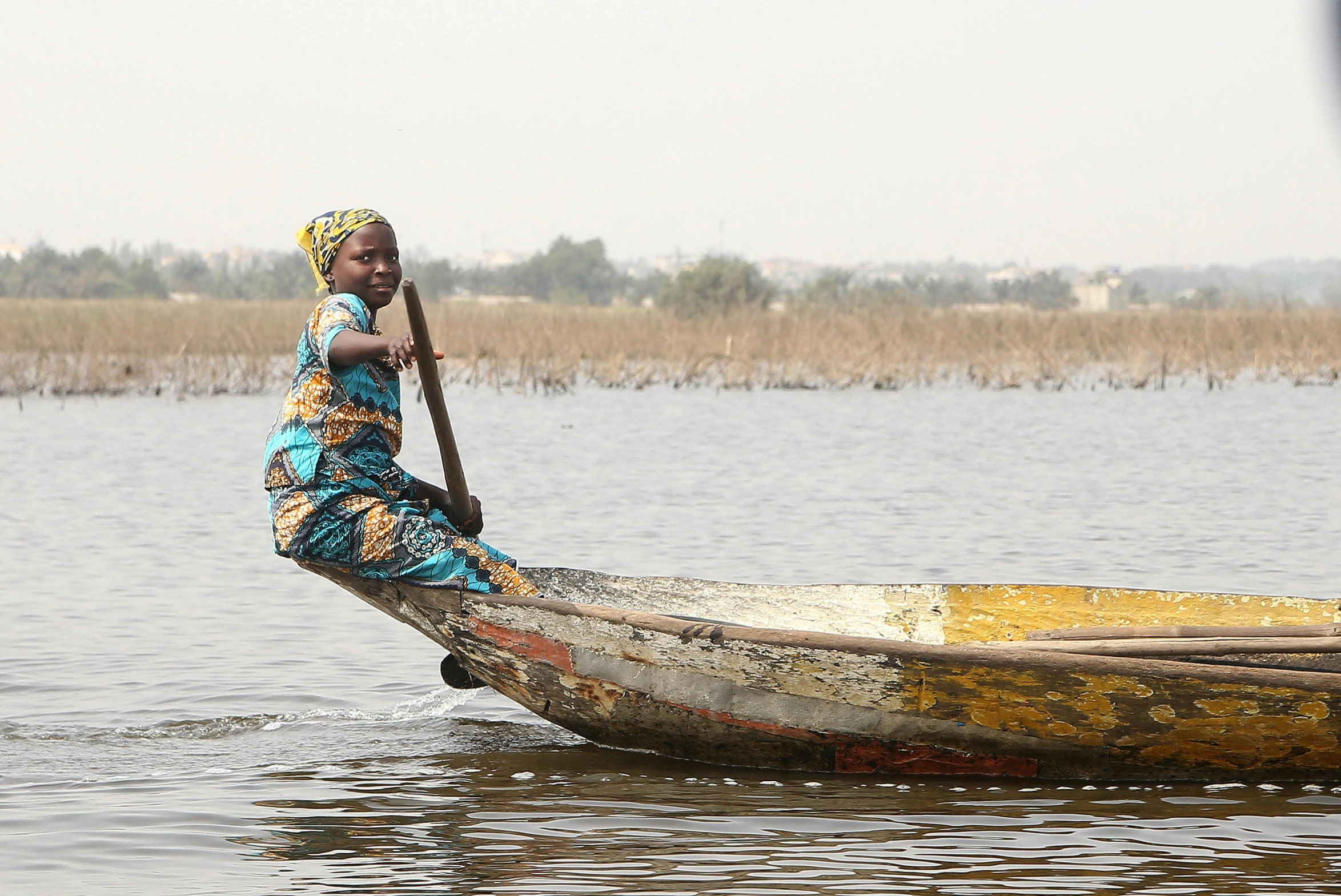 a woman that is sitting in a boat