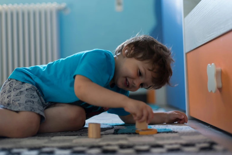 a small child crawling on the floor and playing with some toys