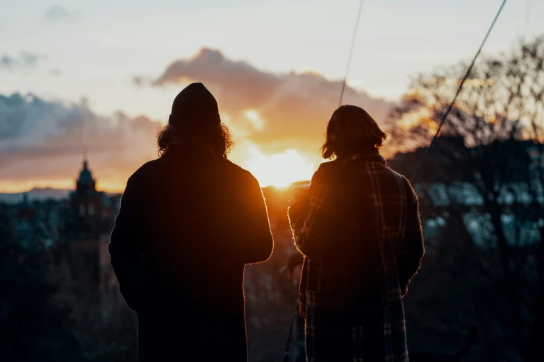 two people that are looking at the sky