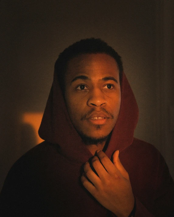 a young man standing in the dark posing