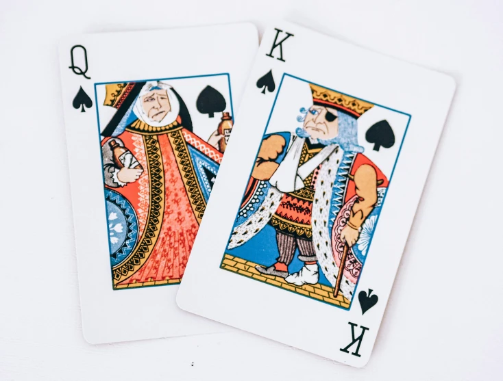 two playing cards with some images in it