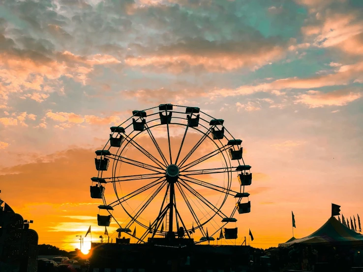 a ferris wheel in a sunset time scene